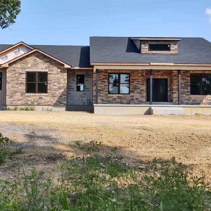 Completed custom home with stone veneer and covered front porch